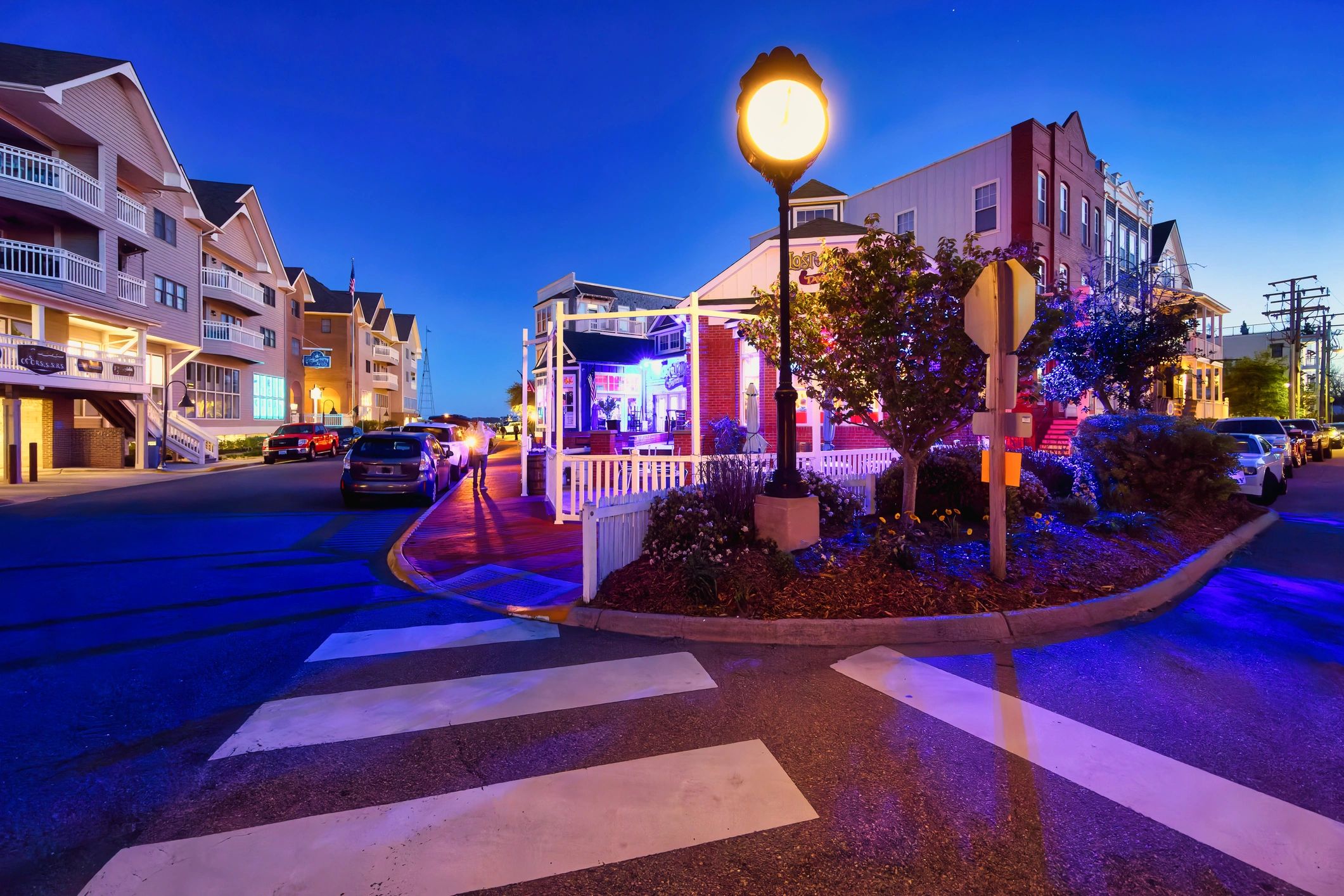 Historic small-town street with shops and warm evening light